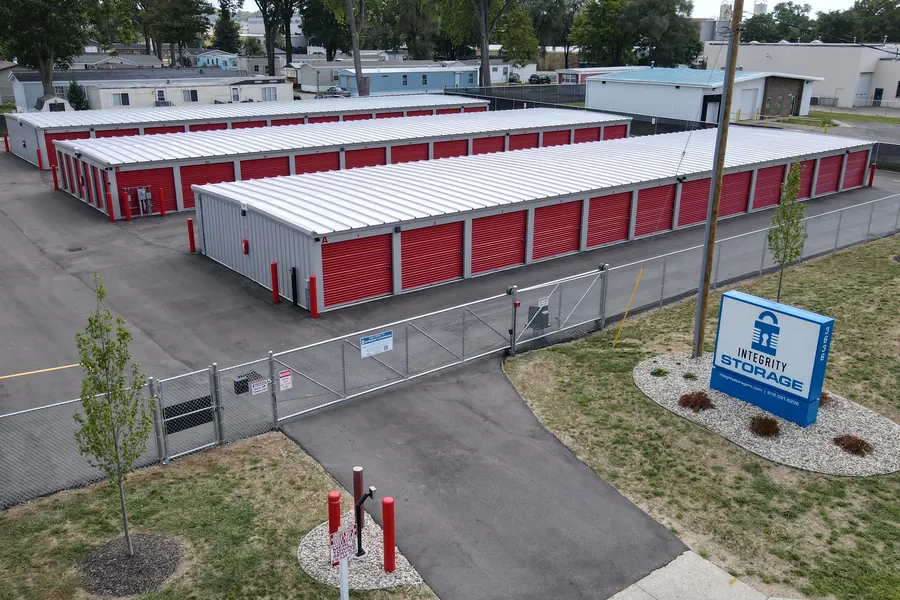 Integrity Storage facility from above with its fenced lot and red roll-up doors